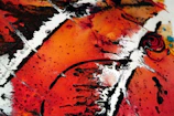 Abstract oil painting featuring bold red and orange swirls.