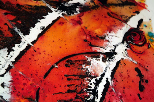 Abstract oil painting featuring bold red and orange swirls.