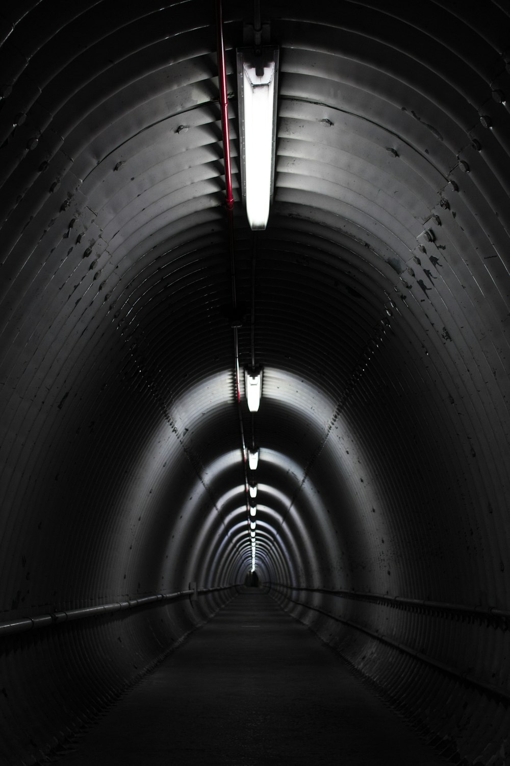 gray concrete tunnel with light