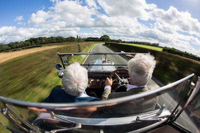 two person ride on car during daytime
