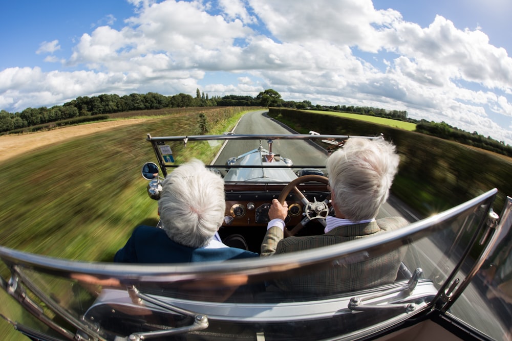 two person ride on car during daytime