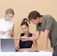 man teaching woman while pointing on gray laptop