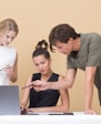 man teaching woman while pointing on gray laptop