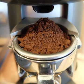 Close-up of coffee grounds being collected in an urban setting.