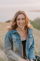 smiling woman sitting on grass during daytime