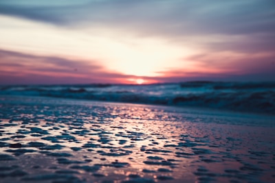 A serene beach scene with pink and gold accents.