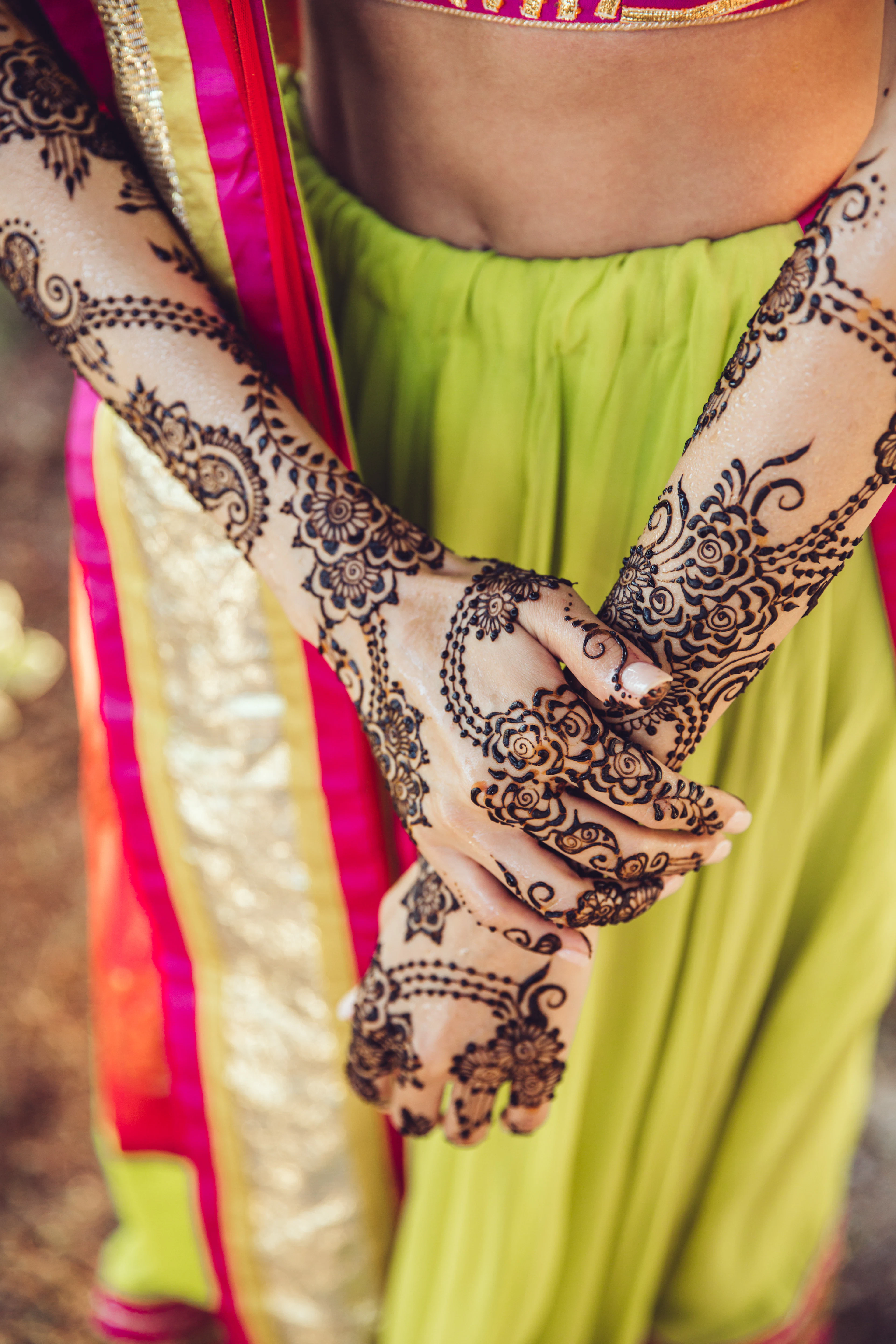 Henna patterns on arms against green silk