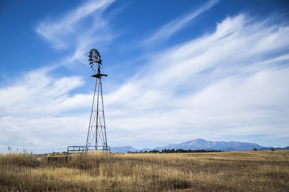 windmill in open field background of mountain view at dayime