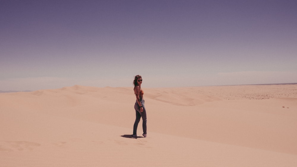 woman standing on sand during daytime