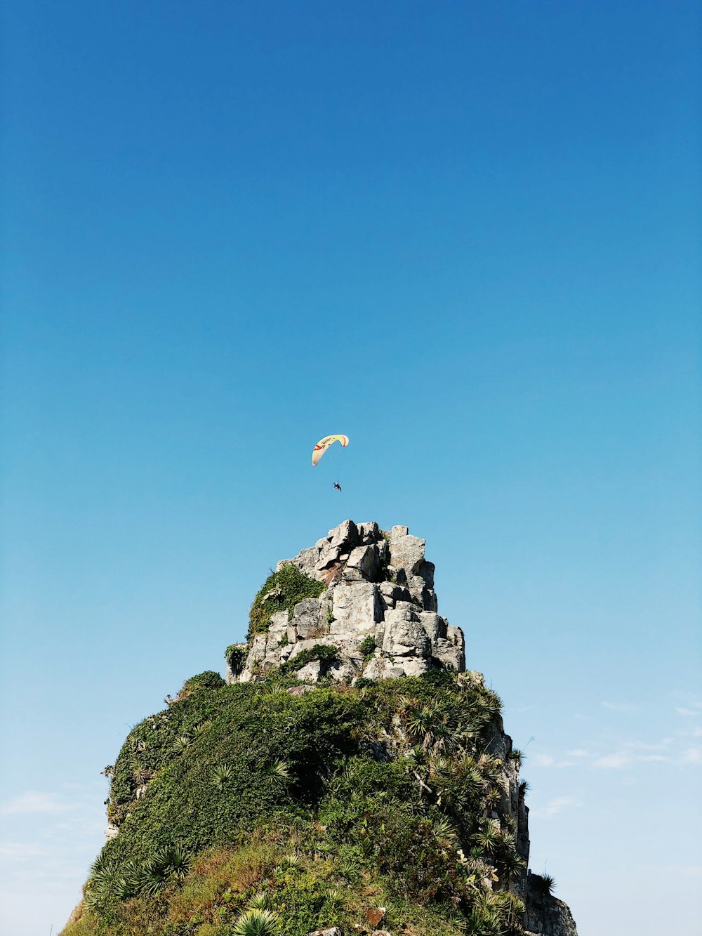 person parachute above castle