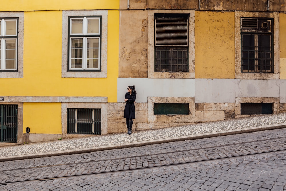 woman standing against building during daytime