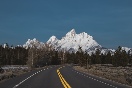 curved road with background of mountain in Grand Teton National Park United States