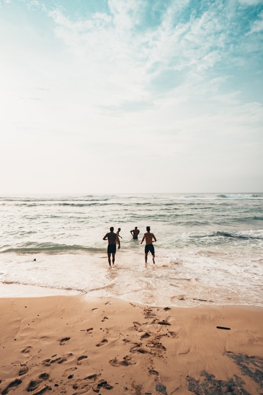 men running toward beach in Uluwatu Temple Indonesia