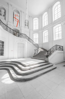 Elegant staircase with sculptural railing in a bright open area
