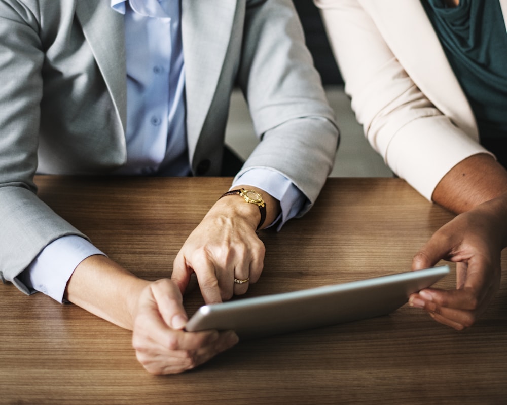 two person watching tablet