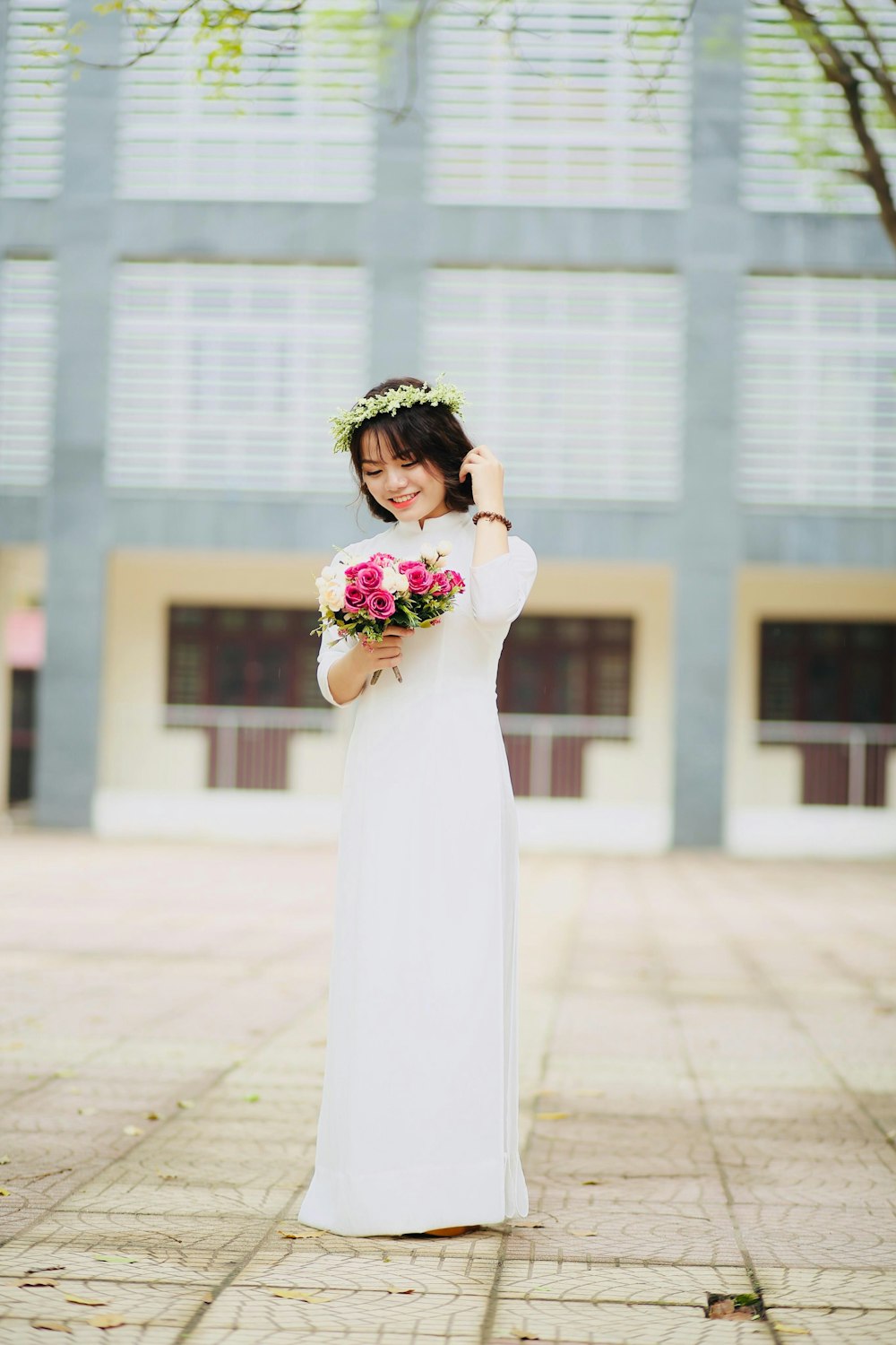 woman holding pink flower bouquet