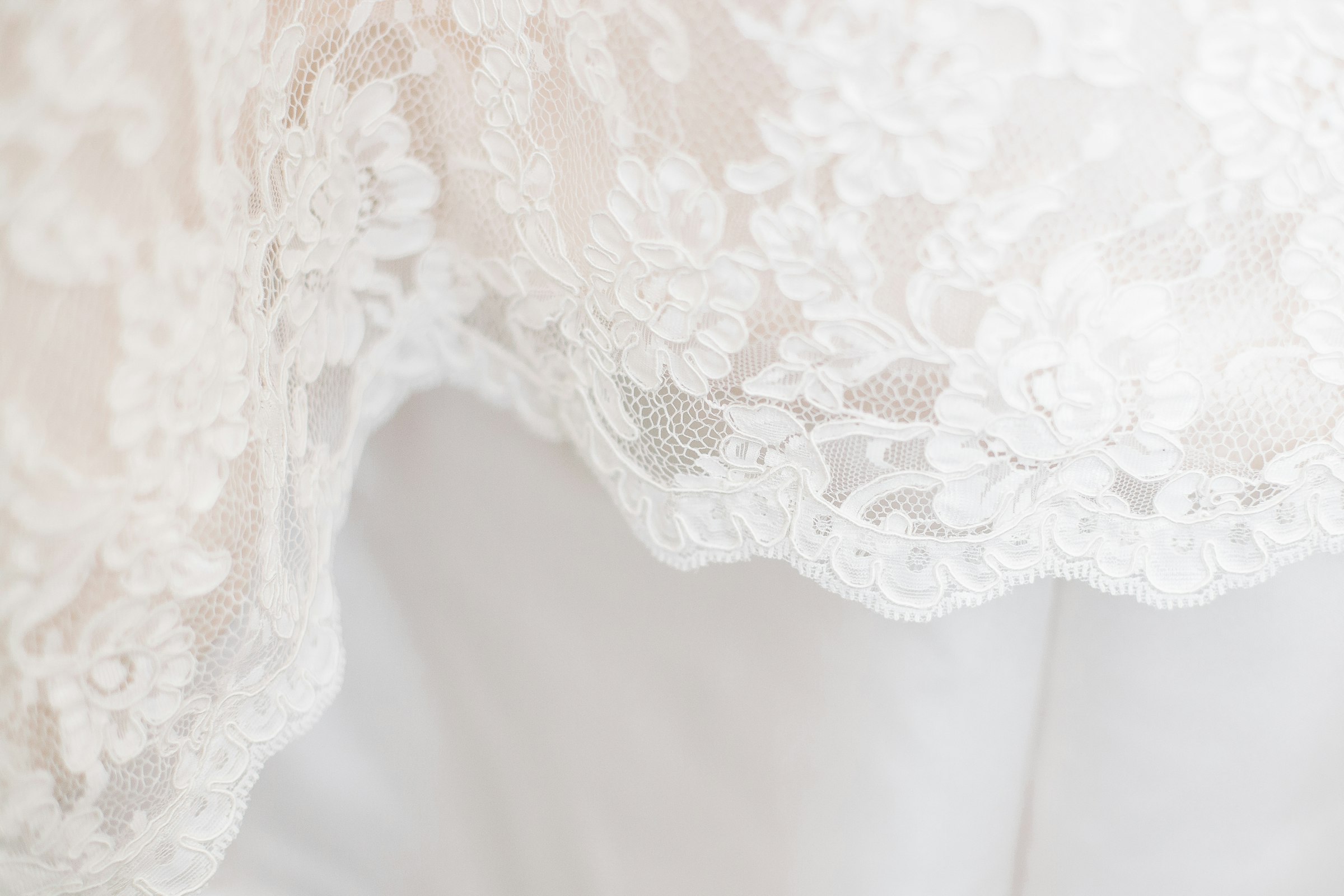 A length of white floral-patterned textile.