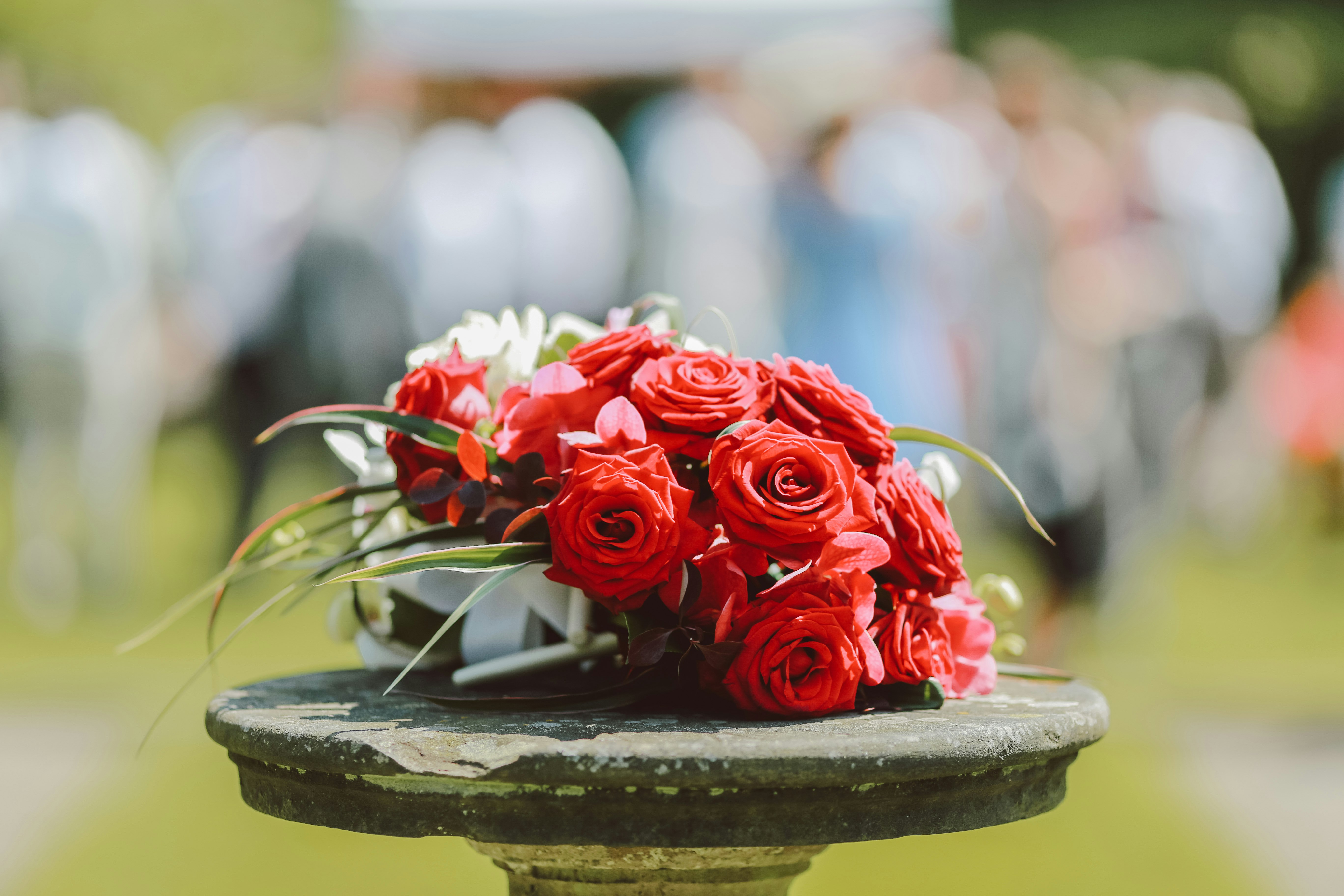 Roses laid with wedding ceremony in background