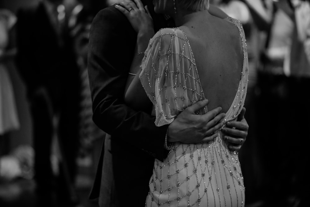 grayscale photo of woman wearing backless dress