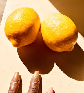 Bright and cheerful yellow nail polish freshly applied, catching the sunlight.