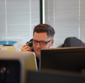 man using IP phone inside room