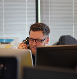 man using IP phone inside room