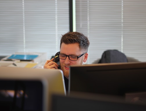 man using IP phone inside room