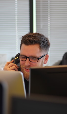 man using IP phone inside room