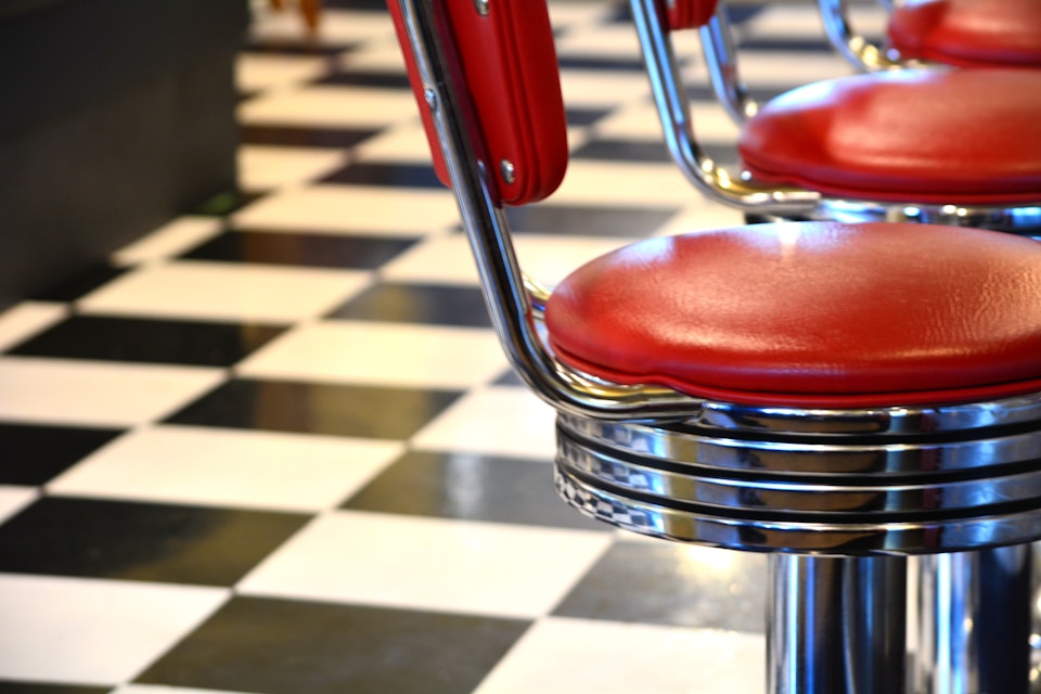 Red chairs in a diner, the ones you'd find at the counter.