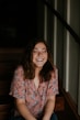 woman sitting on wooden stair smiling