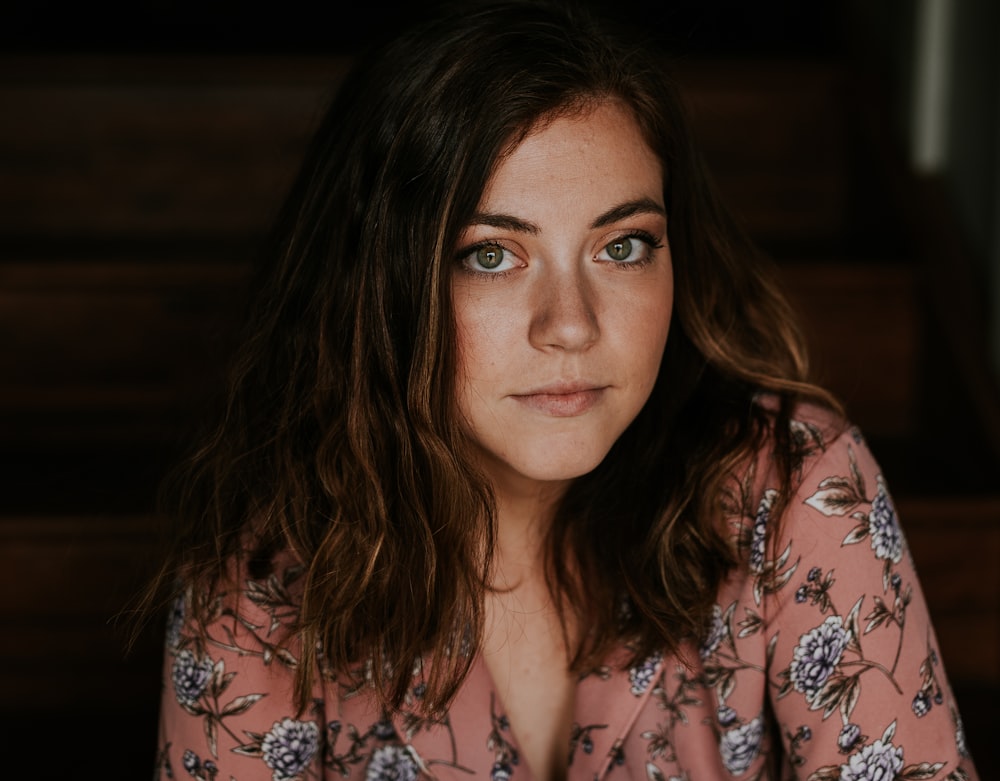 woman in peach and white floral top