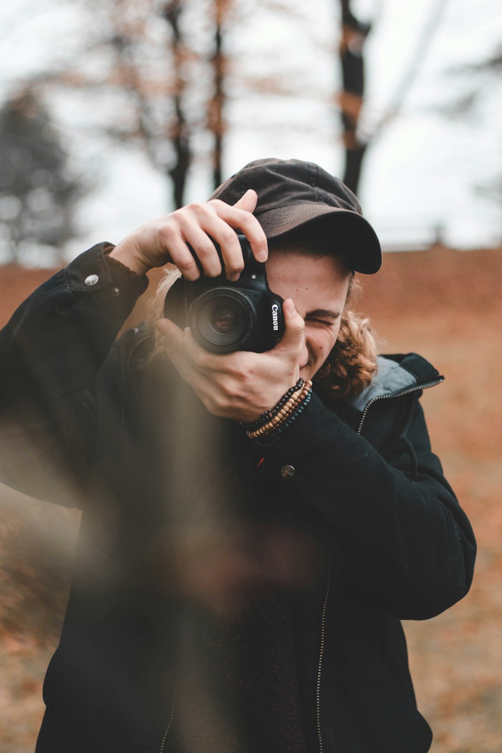 man taking photo using DSLR camera