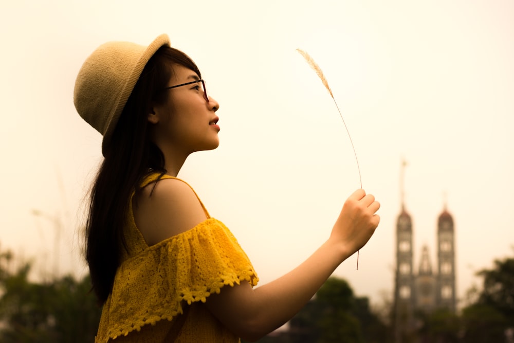 woman holding white grass