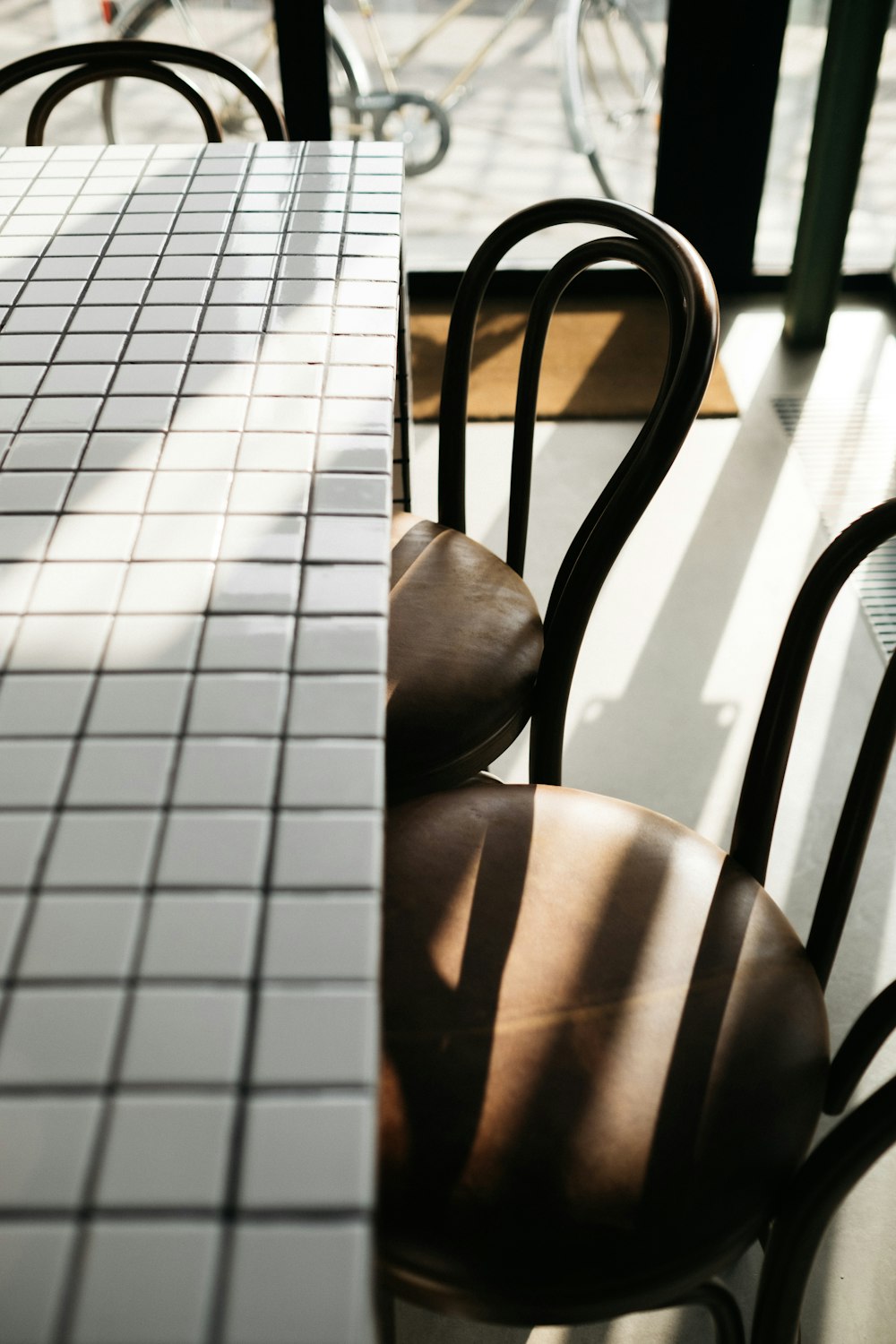 closeup photo of rectangular white table and two chairs