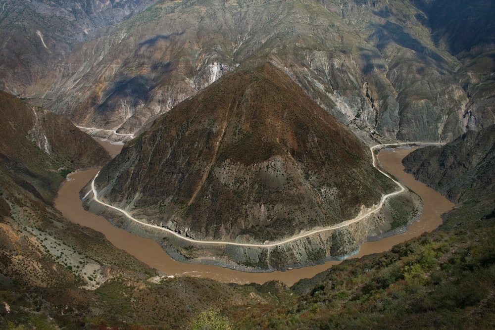 aerial of mountain between body of water