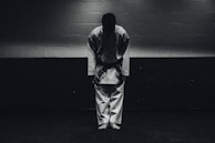 Smiling children bowing respectfully at the start of a karate session.