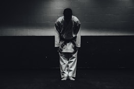 Smiling senior karate practitioners bowing respectfully before training.