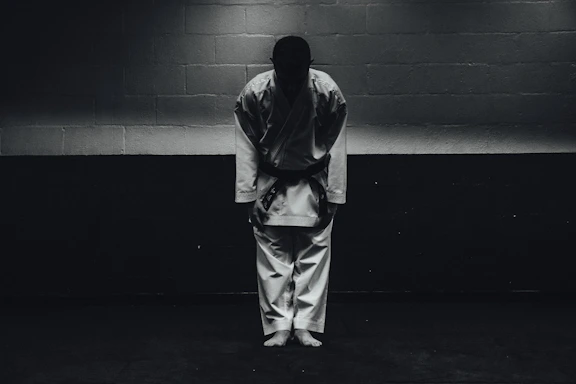 A focused karate student bowing respectfully before a tournament match.