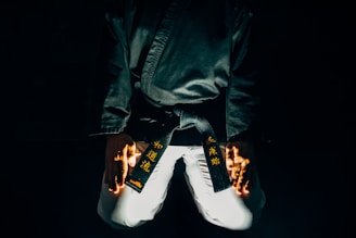 Close-up of a black belt tying the belt tightly before training.