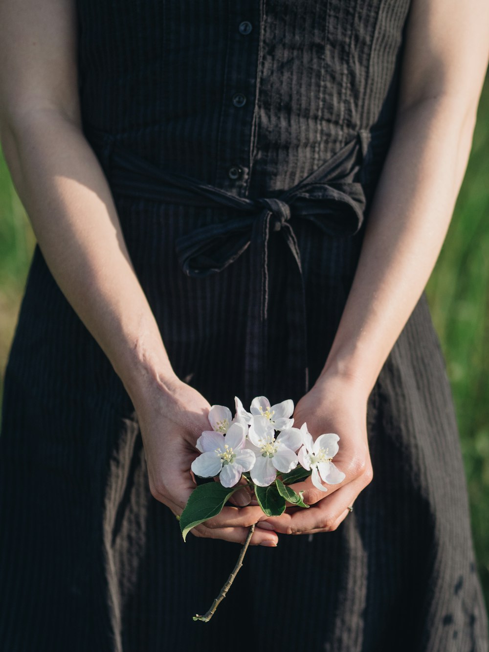 woman holding white flowers