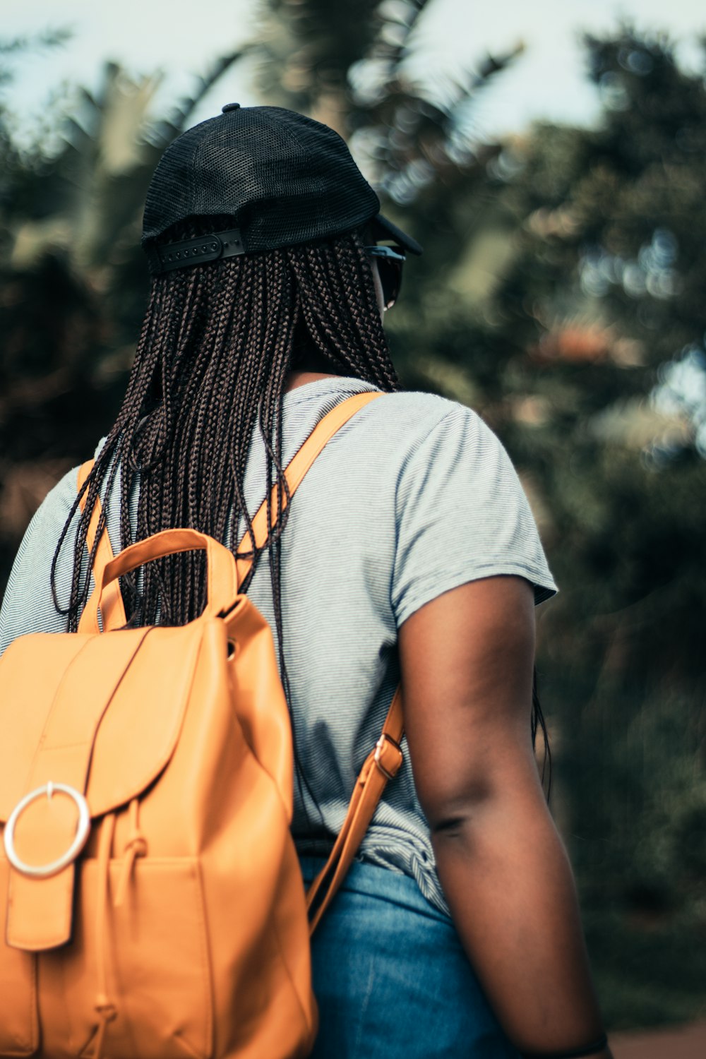 woman with braided hair wearing backpack