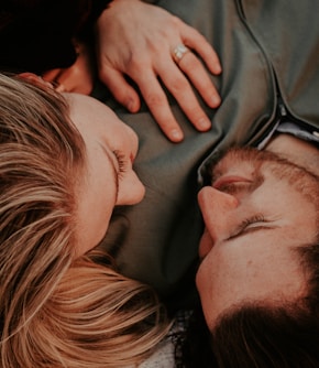 a woman stares into a man's eyes lovingly