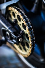 selective focus photography of gold sprocket