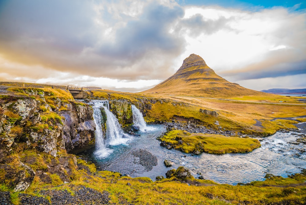 waterfalls and mountains during daytime