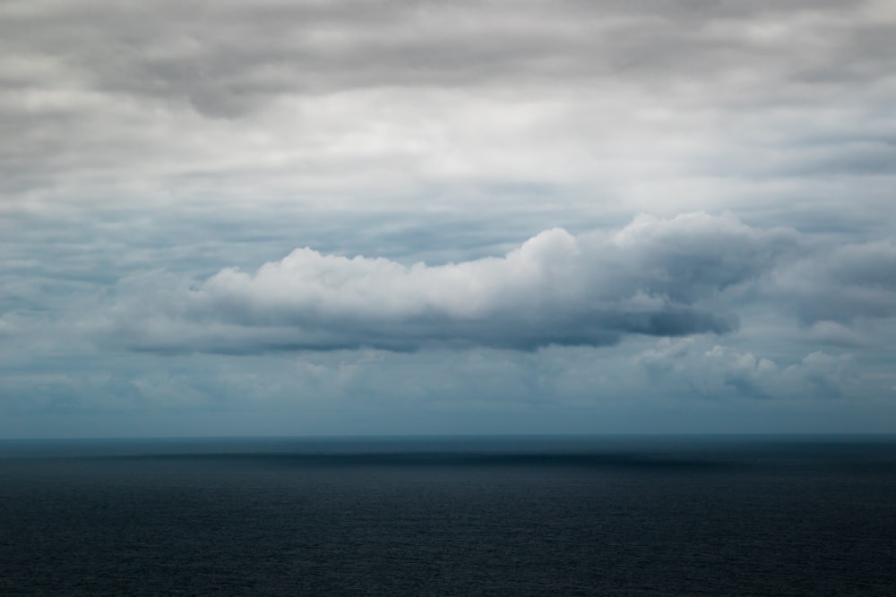 body of water and clouds during daytime