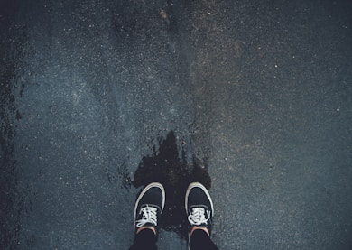 person wearing pair of black sneakers