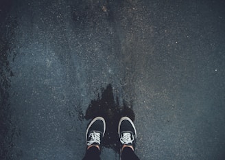 person wearing pair of black sneakers