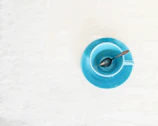 a blue bowl with a spoon inside of it