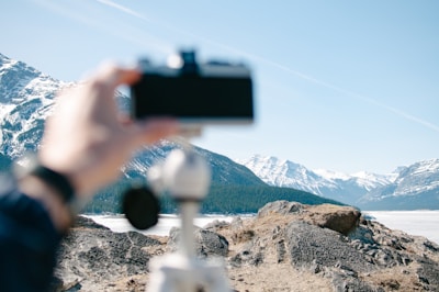 Waleed Malik capturing a scenic mountain landscape with his camera.