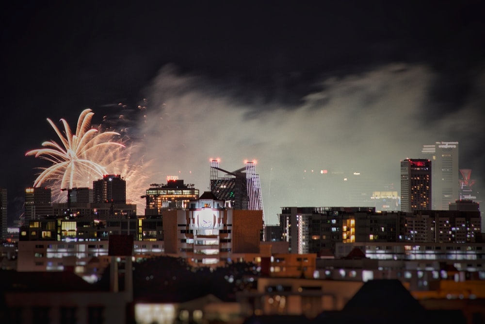 fireworks display near city buildings during night time